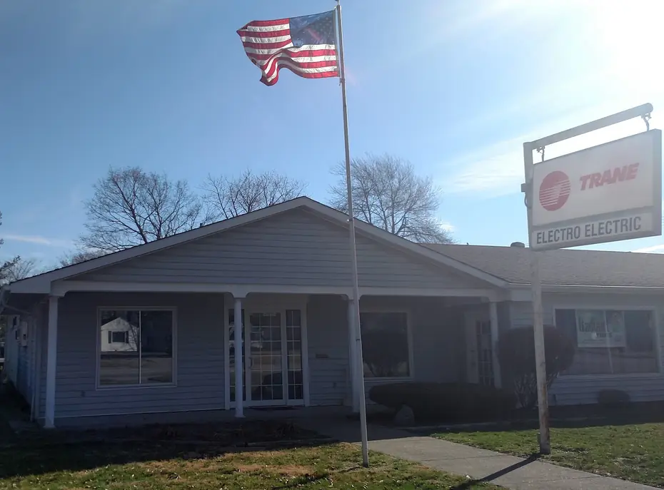 The old Electro Electric shop in Flora with a Trane sign and a flag out front